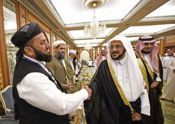 Saudi minister of Islamic affairs Abdullatif Al-Sheikh (2nd R) shaking hands with an Afghan cleric in Jeddah, Afghanistan, on July 10, 2018. (Amer Hilabi/AFP/Getty Images)