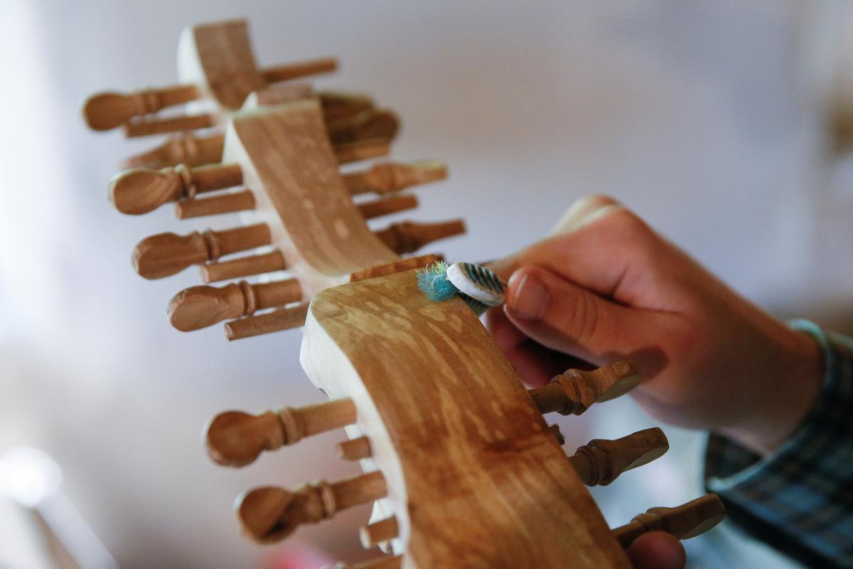 A student of musician Yuriy Fedynsky makes a Ukrainian folk instrument called a torban at a workshop in the village of Kryachkivka, Ukraine Aug. 13, 2018. (Reuters/Valentyn Ogirenko)