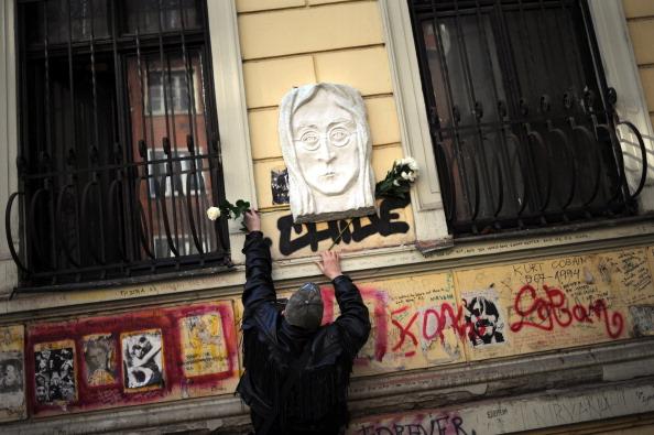 A man lays flowers at a newly inaugurated memorial for John Lennon in Bulgaria, marking the 30th anniversary of the musician's death. (Dimitar Dilkoff/AFP/Getty Images)