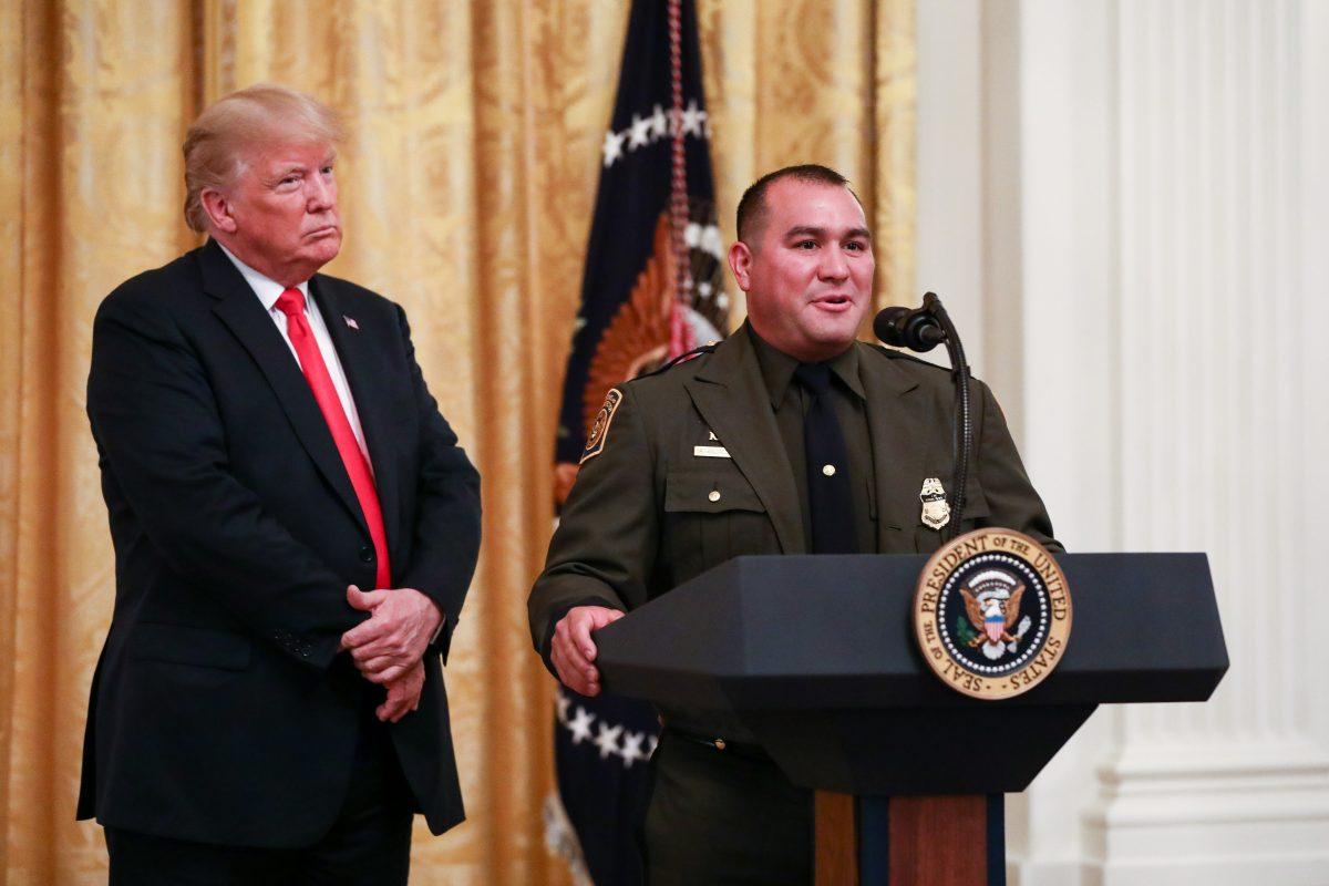 Border Patrol agent Adrian Anzaldua speaks as President Donald Trump looks on at the Salute to the Heroes of ICE and CBP at the White House on Aug. 20, 2018. (Samira Bouaou/The Epoch Times)