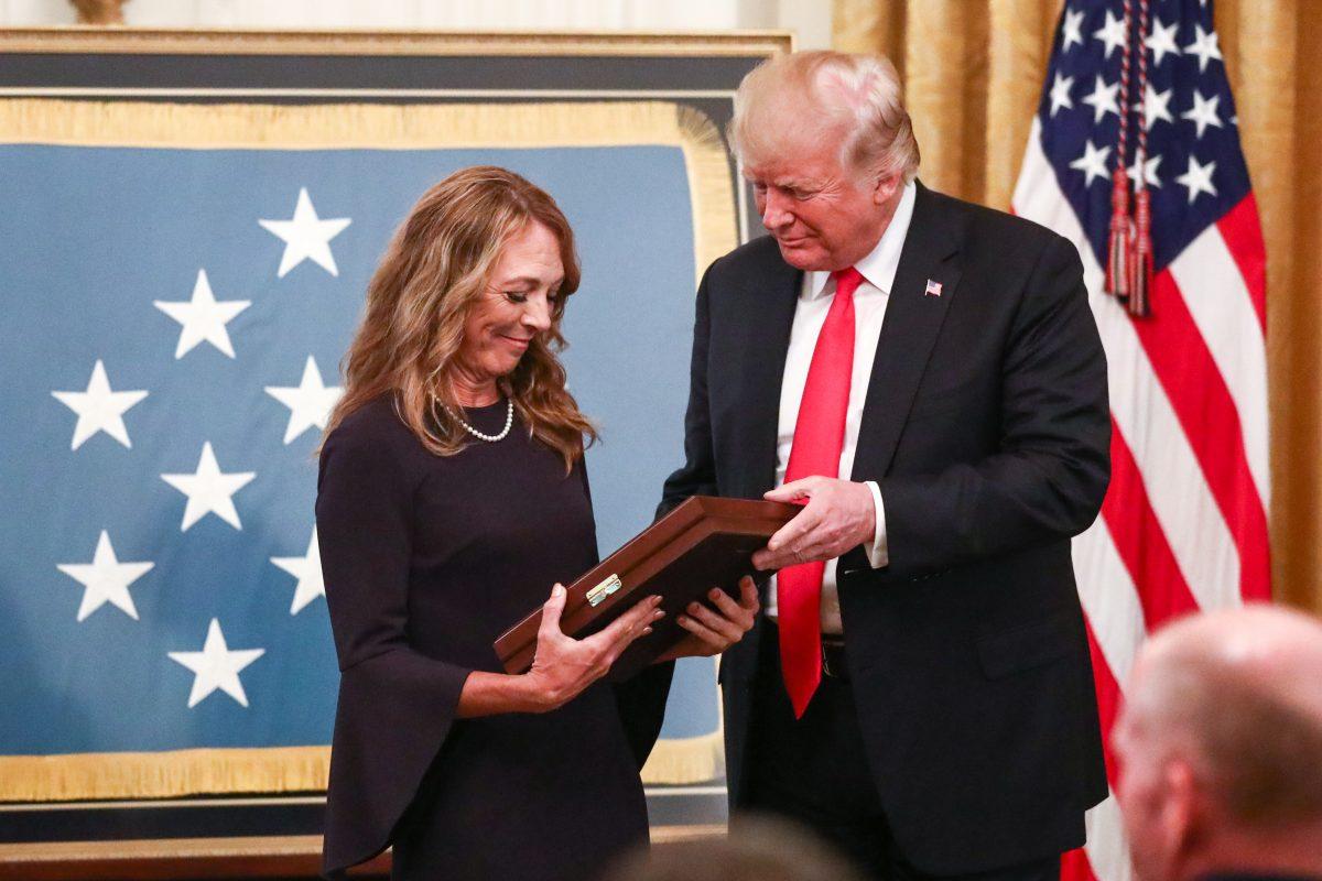 President Donald Trump presents the Medal of Honor posthumously to Valerie Nessel, the widow of Air Force Tech. Sgt. John A. Chapman, for conspicuous gallantry, at the White House on Aug. 22, 2018. (Samira Bouaou/The Epoch Times)