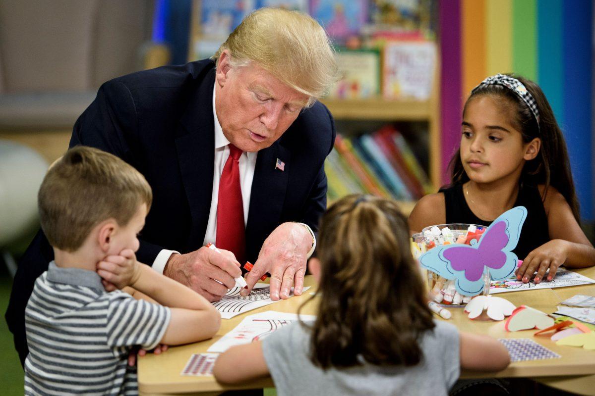 President Donald Trump colors an American flag during a tour Nationwide of Children's Hospital in Columbus, Ohio, on Aug. 24, 2018. (Brendan Smialowski/AFP/Getty Images)