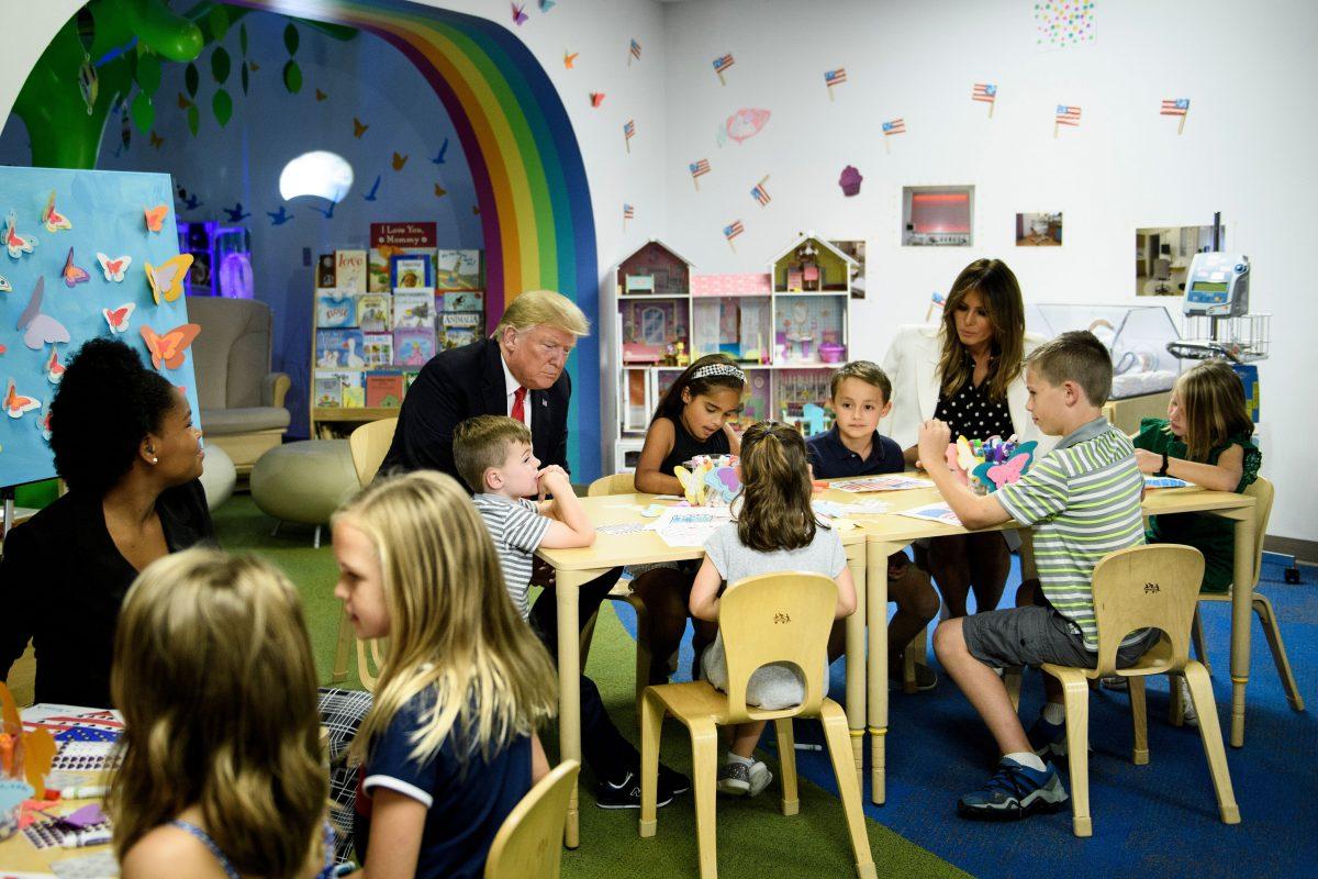 President Donald Trump and First Lady Melania Trump sit with children during a tour Nationwide Children's Hospital in Columbus, Ohio, on Aug. 24, 2018. (Brendan Smialowski/AFP/Getty Images)