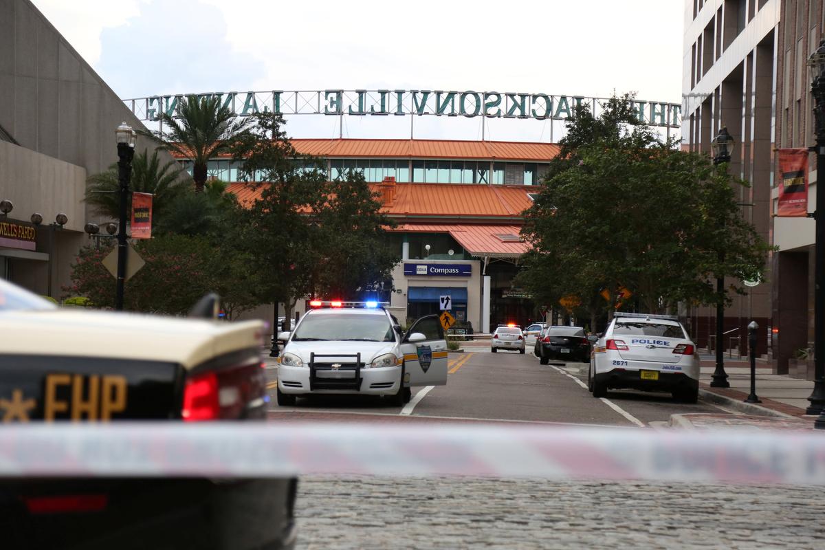 Police officers cordon off a street outside The Jacksonville Landing after a shooting during a video game tournament in Jacksonville, Florida August 26, 2018. (Reuters/Joey Roulette)