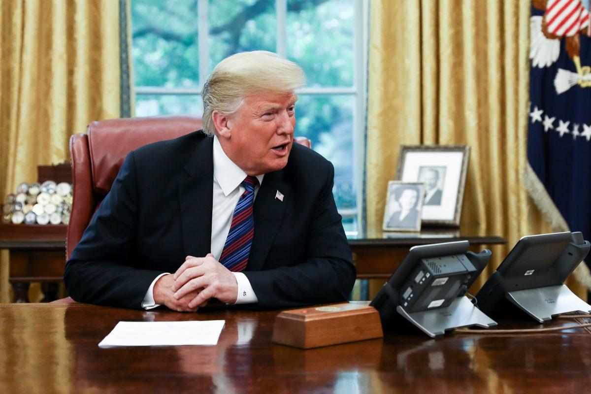 President Donald Trump conducts a phone call with President Pena Nieto of Mexico via a translator, in the Oval Office of the White House in Washington on Aug. 27, 2018. Trump announced that Mexico has agreed to enter into a new trade deal, the United States-Mexico trade agreement. (Samira Bouaou/The Epoch Times)