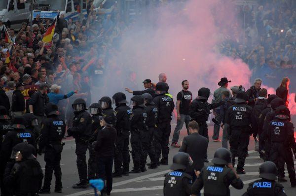 Riot police stand guard as rival demonstrators face off in the wake of a stabbing in Chemnitz, Germany, on Aug. 27, 2018. (Matthias Rietschel/Reuters)