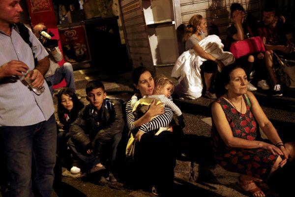 Passengers who were onboard the Eleftherios Venizelos ferry during a fire, wait to be transported to another terminal at the port of Piraeus, Greece, August 29, 2018. (Reuters/Alkis Konstantinidis)