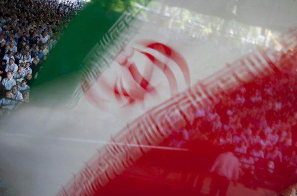 An Iranian flag flutters as worshippers attend Friday prayers in Tehran in this file photo. (Reuters/Morteza Nikoubazl)