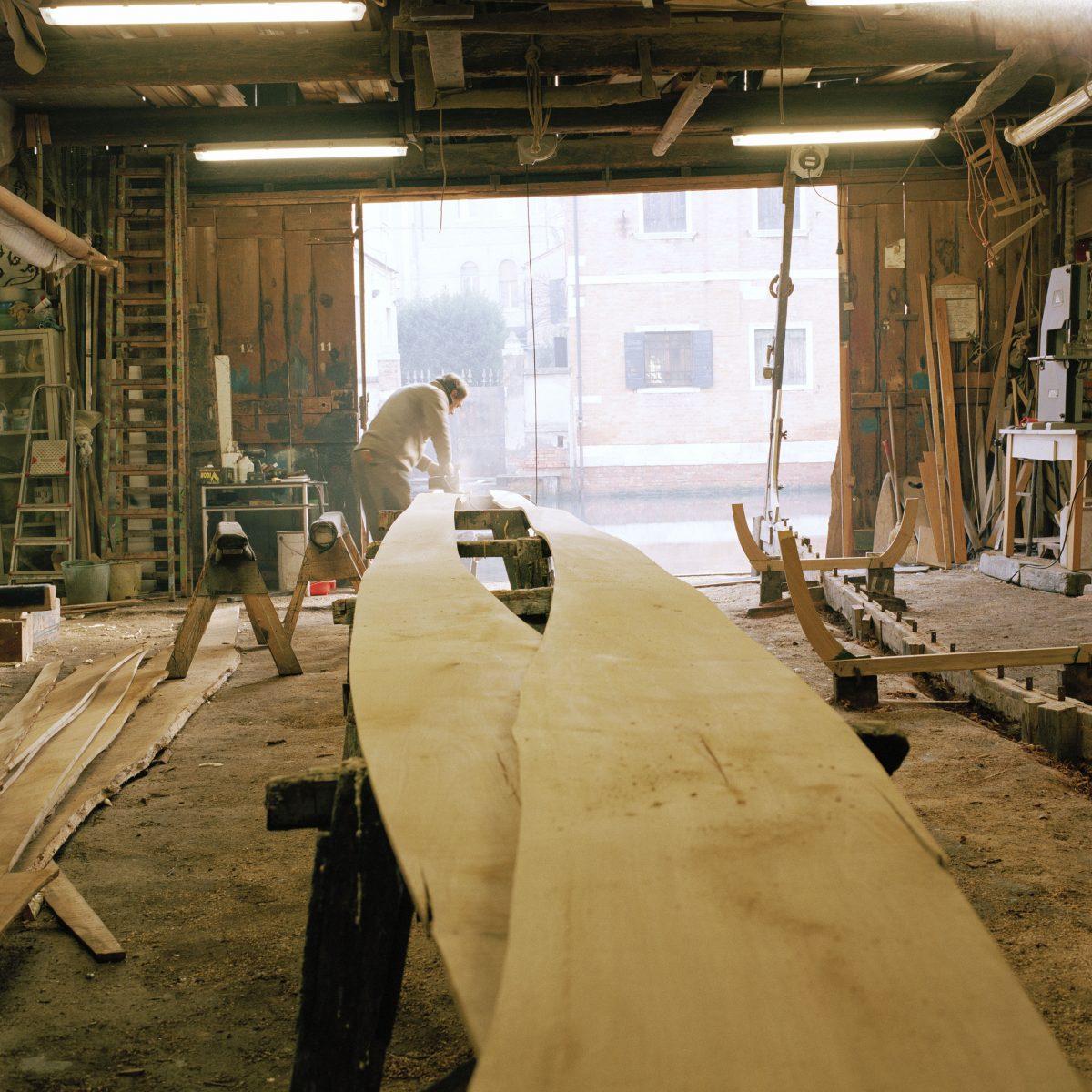 The 1884 boat-length wooden beam (R) with its metal markers is still used to construct gondolas. (Susanna Pozzoli/Michelangelo Foundation for Creativity and Craftsmanship)