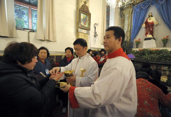 Chinese worshippers attend a holy communion during Christmas Mass at a Catholic church in Beijing on Dec. 24, 2009. (Liu Jin/AFP/Getty Images)