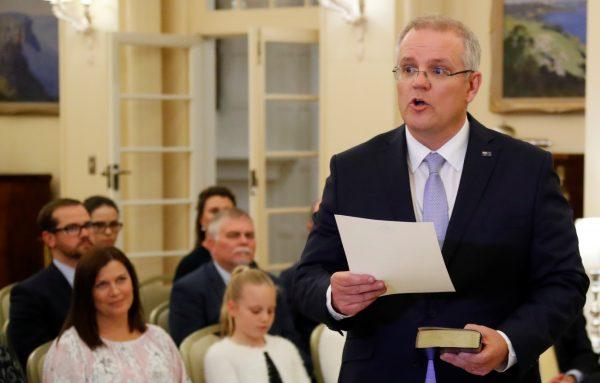 The new Australian Prime Minister Scott Morrison attends a swearing-in ceremony as his wife Jenny looks on, in Canberra, Australia on Aug. 24, 2018. (REUTERS/David Gray)