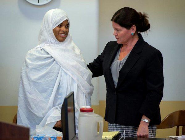 Defendant Hujrah Wahhaj reacts as she stands with her defense lawyer Marie Legrand Miller during a hearing in Taos County District Court in Taos County, New Mexico, on Aug. 28, 2018. (Eddie Moore/Pool via Reuters)