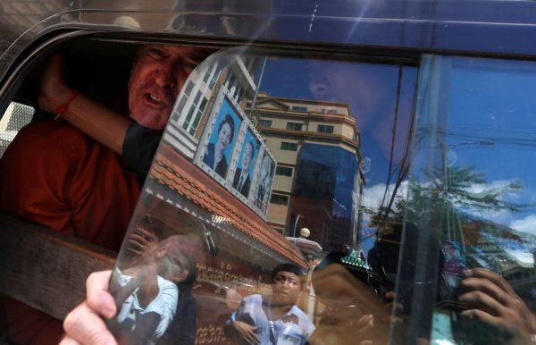 Australian filmmaker James Ricketson shouts inside a prison truck as he leaves the Municipal Court of Phnom Penh, Cambodia, Aug. 31, 2018. (Reuters/Samrang Pring)