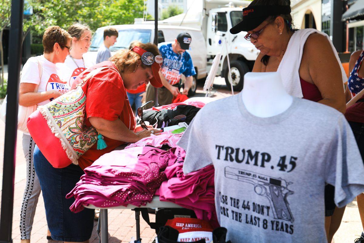 Vendors sell Trump merchandise outside the Ford Center in Evansville, Ind., before President Donald Trump’s Make America Great Again rally, on Aug. 30, 2018.