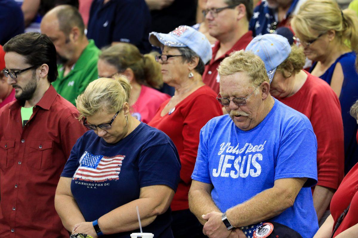 Audience members during the prayer at President Donald Trump’s Make America Great Again rally in Evansville, Ind., on Aug. 30, 2018. (Charlotte Cuthbertson/The Epoch Times)