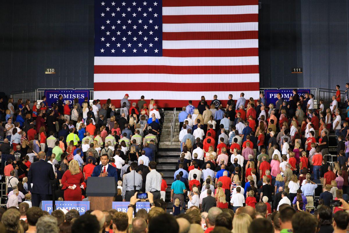 Audience members sing the national anthem at President Donald Trump’s Make America Great Again rally in Evansville, Ind., on Aug. 30, 2018. (Charlotte Cuthbertson/The Epoch Times)