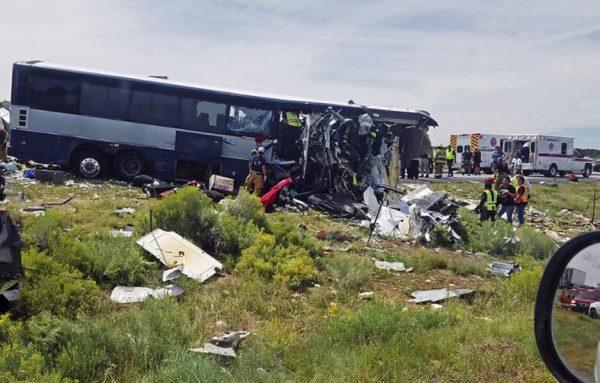First responders working the scene of a collision between a Greyhound passenger bus and a semi-truck on Interstate 40 near the town of Thoreau, N.M., near the Arizona border, Thursday, Aug. 30, 2018. (Chris Jones via AP)