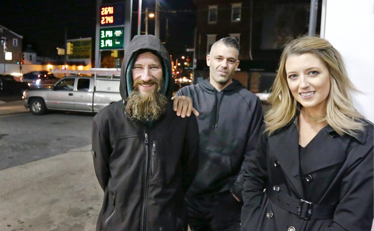 Johnny Bobbitt (L), Kate McClure (R) and McClure's boyfriend Mark D'Amico pose at a Citgo station in Philadelphia. McClure and D'Amico raised more than $400,000 for Bobbitt, a homeless man, but withheld the funds. On Aug. 30 a New Jersey judge issued an order compelling them to hand over the funds. (Elizabeth Robertson/The Philadelphia Inquirer via AP)
