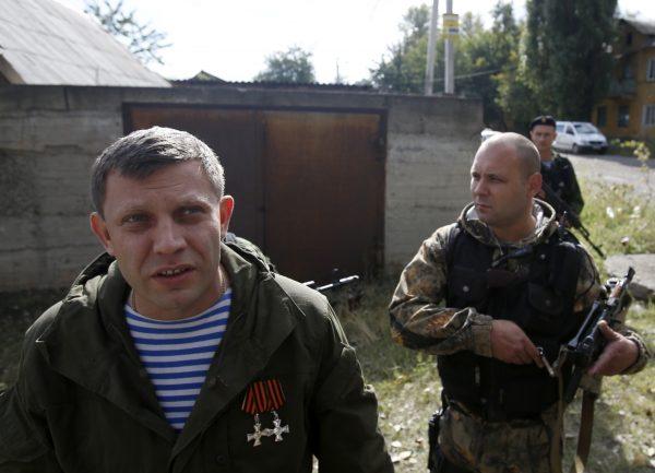 Alexander Zakharchenko, the leader of pro-Russian rebels in Donetsk, left, addresses the media after shelling in the town of Donetsk, eastern Ukraine. The leader of the Russia-backed separatists fighting in eastern Ukraine's Donetsk region was killed Friday, Aug. 31, 2018 by an explosion at a cafe, the separatists' news agency said Friday. (AP Photo/Darko Vojinovic, File)