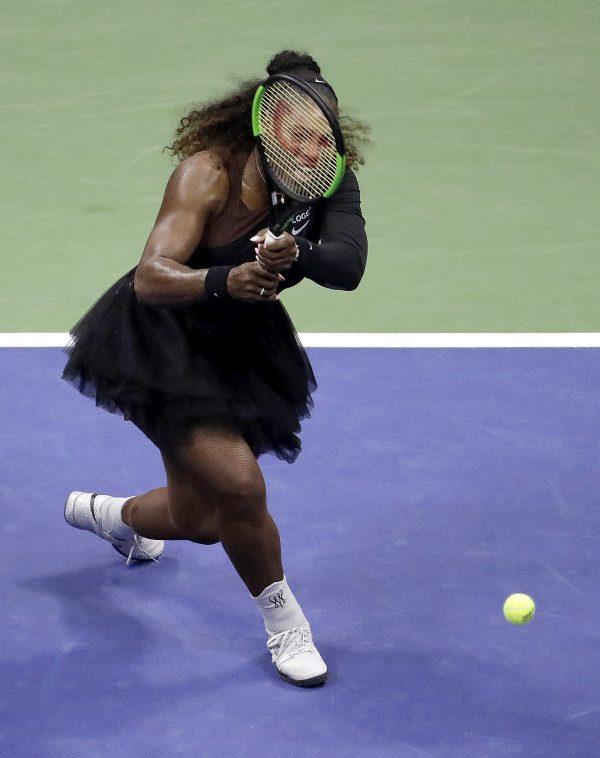 Serena Williams returns a shot to Venus Williams during the third round of the U.S. Open tennis tournament in New York on Aug. 31, 2018, . (AP Photo/Julio Cortez)