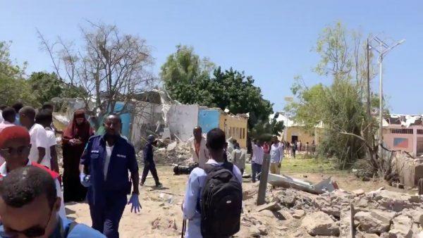 People look at debris at the site of a blast in Mogadishu, Somalia, September 2, 2018 in this still image obtained from a social media video. (Munasar Mohamed/via Reuters)