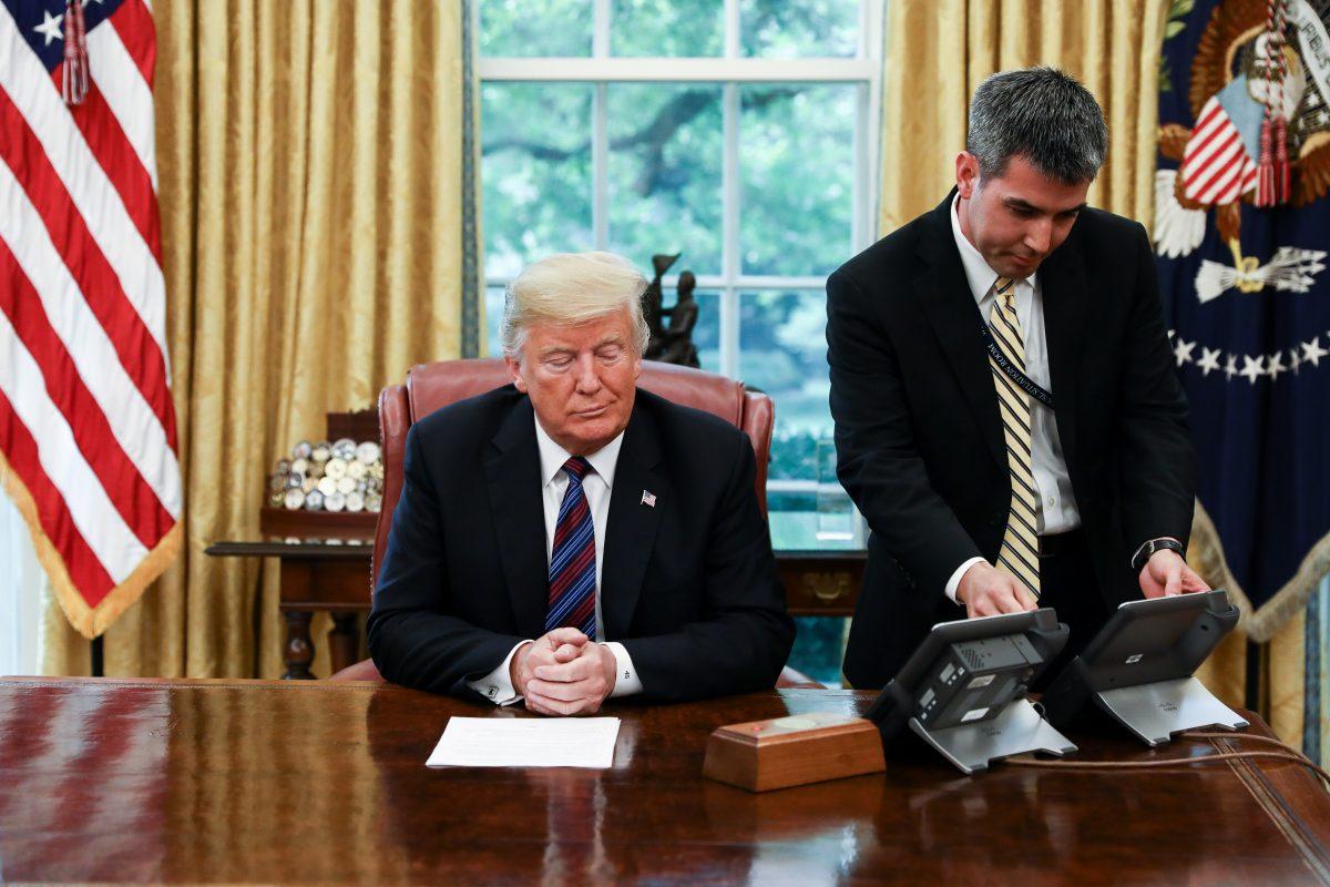 President Donald Trump conducts a phone call with President Pena Nieto of Mexico via a translator, in the Oval Office of the White House in Washington on Aug. 27, 2018. Trump announced that Mexico has agreed to enter into a new trade deal, the United States-Mexico trade agreement. (Samira Bouaou/The Epoch Times)