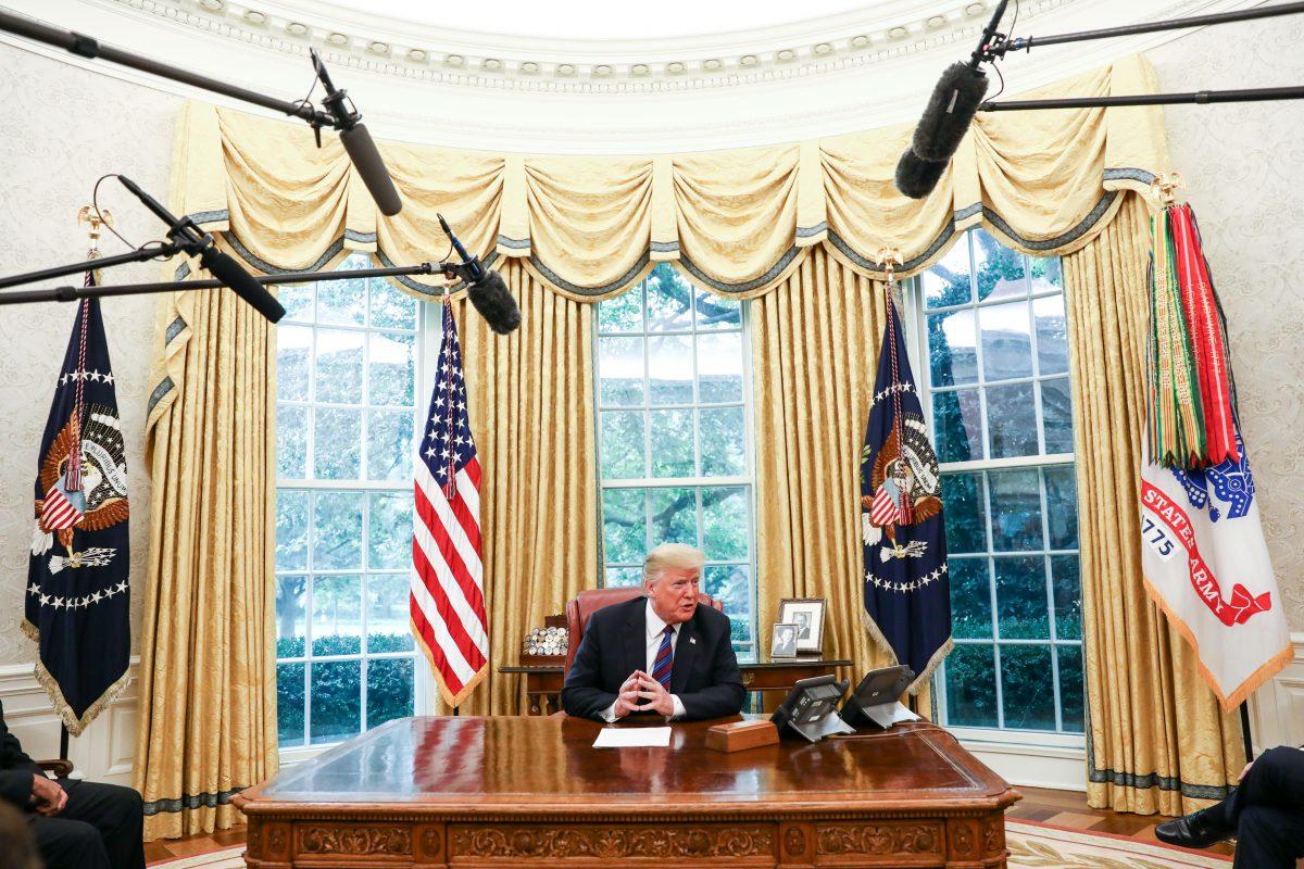 President Donald Trump conducts a phone call about trade with President Pena Nieto of Mexico via a translator, in the Oval Office. (Samira Bouaou/The Epoch Times)