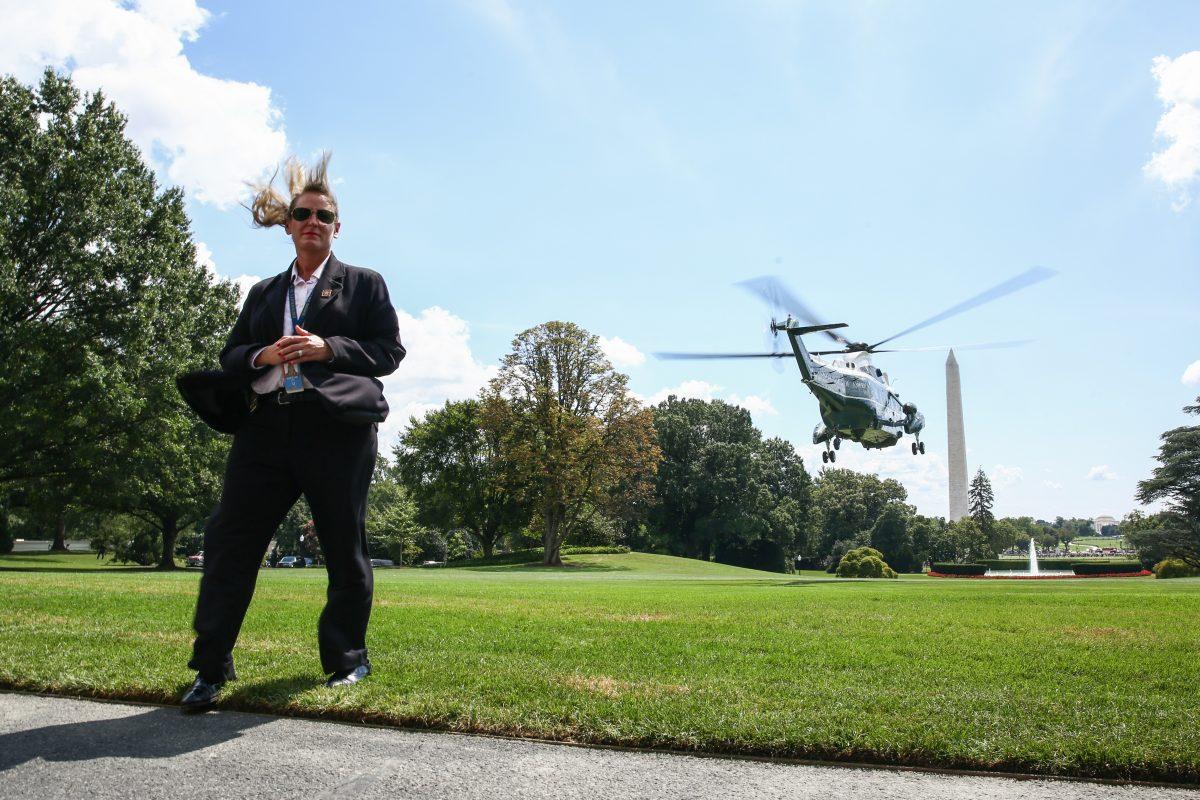A Secret Service agent stands guard as President Donald Trump departs on Marine One from the White House to Charlotte, N.C., on Aug. 31, 2018. (Samira Bouaou/The Epoch Times)