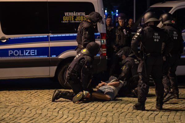 Riot police arrest a man near the intersection of two rival protests in the German city of Chemnitz, on Sept. 1, 2018. (Jens Schlueter/Getty Images)