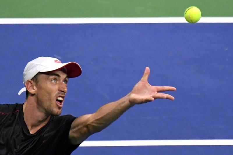 John Millman of Australia serves to Roger Federer of Switzerland in a round of 16 match on day eight of the 2018 U.S. Open tennis tournament at USTA Billie Jean King National Tennis Center on Sep. 3, 2018. (Danielle Parhizkaran/USA Today Sports/Reuters)