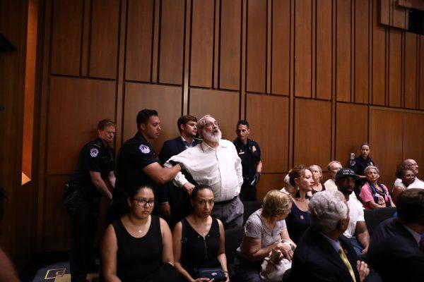 A heckler interrupts the proceedings during the first day of hearings to confirm Brett Kavanaugh to the Supreme Court in Washington, on Sept. 4, 2018. (Samira Bouaou/Epoch Times)