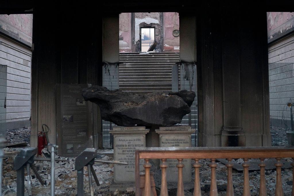A meteorite on exhibit is seen inside the entrance of the National Museum after an overnight fire in Rio de Janeiro, Brazil, Monday, Sept. 3, 2018. Firefighters dug through the burned-out hulk of Brazil’s National Museum on Monday, a day after fire gutted the building, as the country mourned the irreplaceable treasures lost and pointed fingers over who was to blame. (AP/Leo Correa)