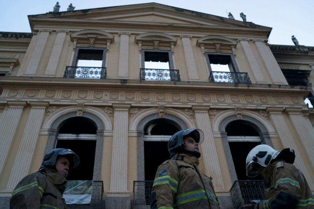 Firefighters stand in front of the National Museum after an overnight fire in Rio de Janeiro, Brazil, Monday, Sept. 3, 2018. Firefighters dug through the burned-out hulk of Brazil’s National Museum on Monday, a day after fire gutted the building, as the country mourned the irreplaceable treasures lost and pointed fingers over who was to blame. (AP/Leo Correa)