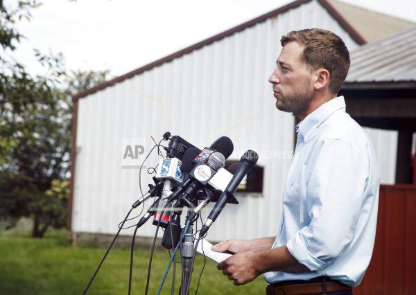 In this Aug. 22, 2018 file photo, Dane Lang, co-owner of Yarrabee Farms, speaks to the media on the family farm in Brooklyn, Iowa. Cristhian Bahena Rivera, a former employee at the farm who was charged with the murder of Iowa college student Mollie Tibbetts, was known by another name where he worked for the last four years: John Budd. (Brian Powers /The Des Moines Register via AP)
