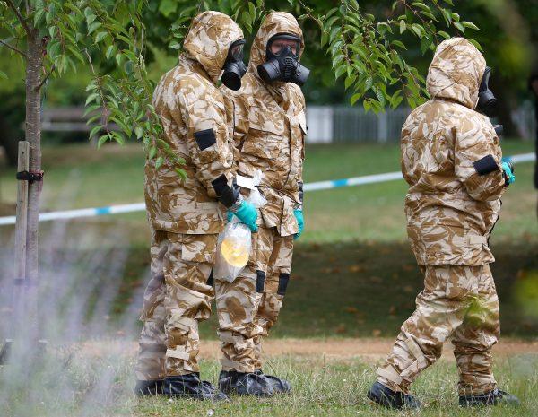 People in military hazardous material protective suits collect an item in Queen Elizabeth Gardens in Salisbury, UK, July 19, 2018. (Reuters/Hannah McKay/File Photo)