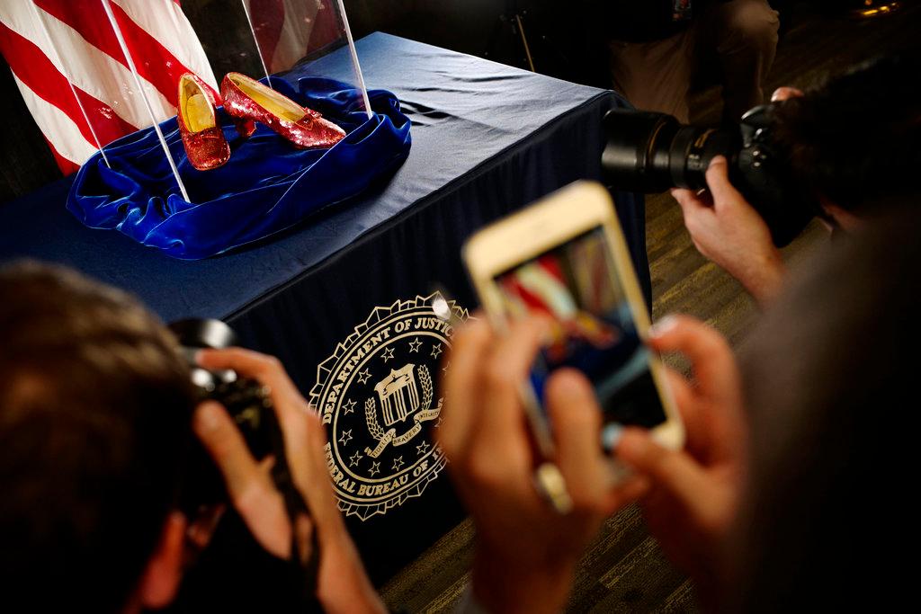 A pair of ruby slippers once worn by actress Judy Garland in the "The Wizard of Oz" are displayed at a news conference Tuesday, Sept. 4, 2018, at the FBI office in Brooklyn Center, Minn. (Richard Tsong-Taatarii/Star Tribune via AP)