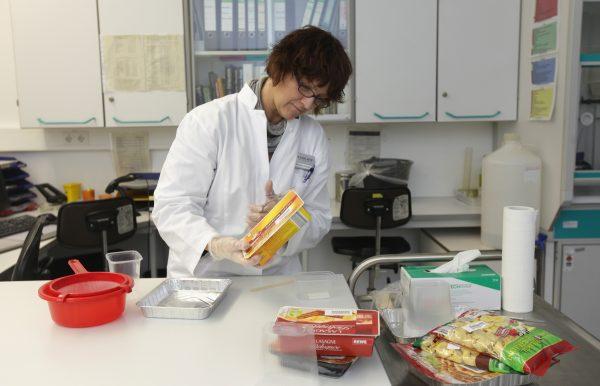 A laboratory technician extracts a sample from a package of ready-made lasagna to check the contents for possible horsemeat in Krefeld, Germany, on Feb. 14, 2013. (Juergen Schwarz/Getty Images)