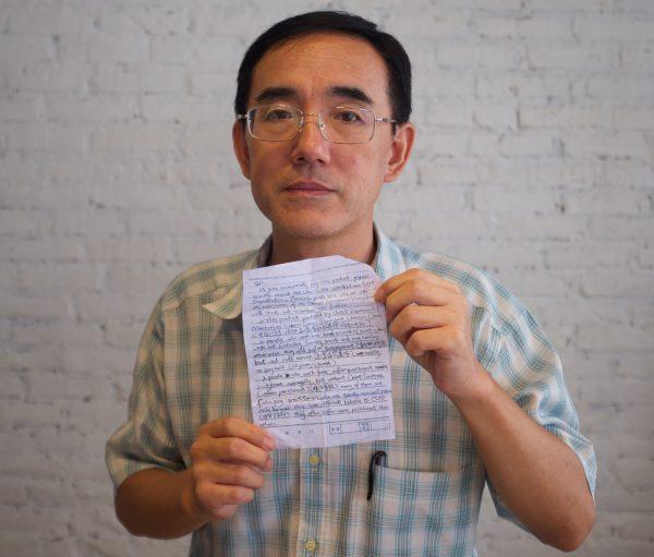 Sun Yi holding the SOS letter he wrote, which made its way around the world and back to him. (Courtesy Flying Cloud Productions)