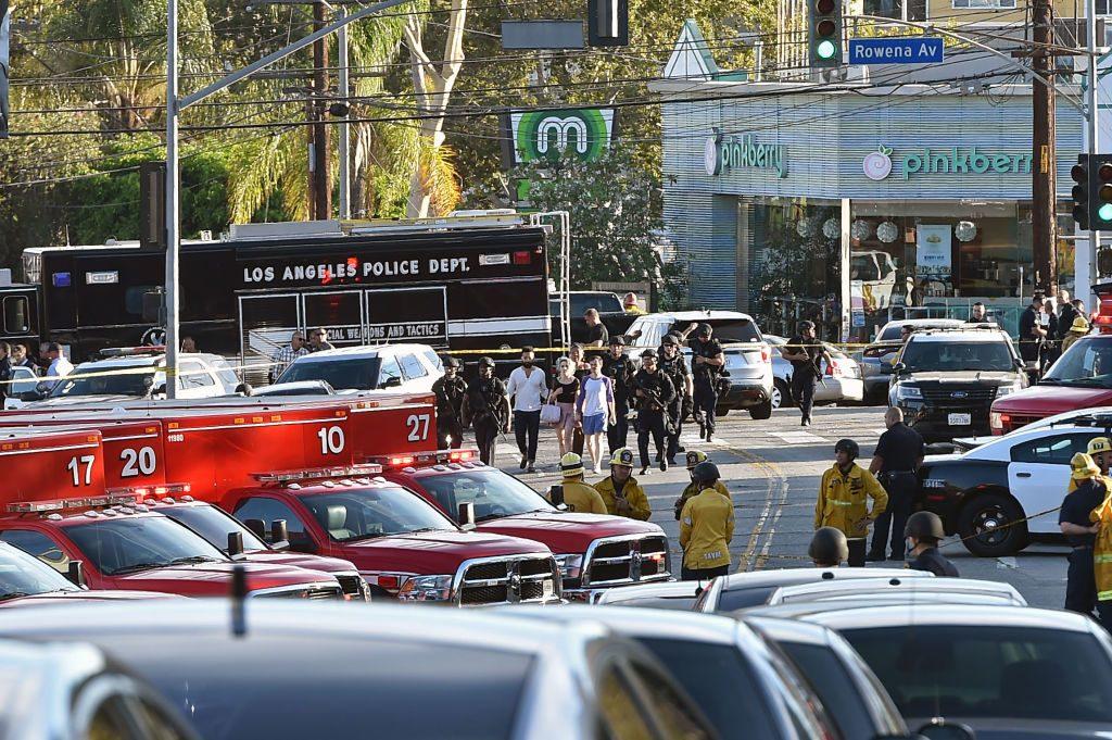 Police officers escort people after a suspect barricaded inside a Trader Joe's supermarket in the Silverlake neighborhood of Los Angeles, on July 21, 2018. (ROBYN BECK/AFP/Getty Images)