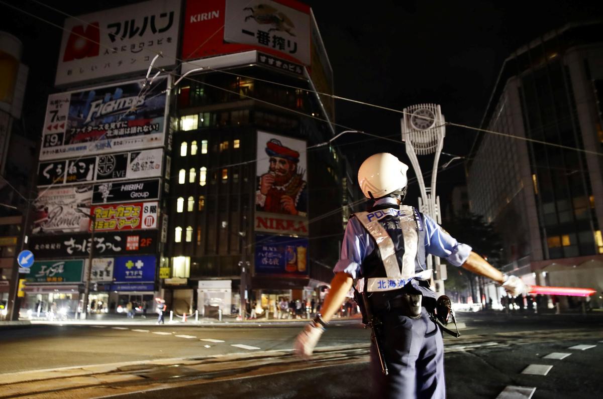 A police officer is seen during blackout after a powerful earthquake hit the area at a cross-point in Sapporo, Japan, Sept. 6, 2018. (Kyodo/Reuters)