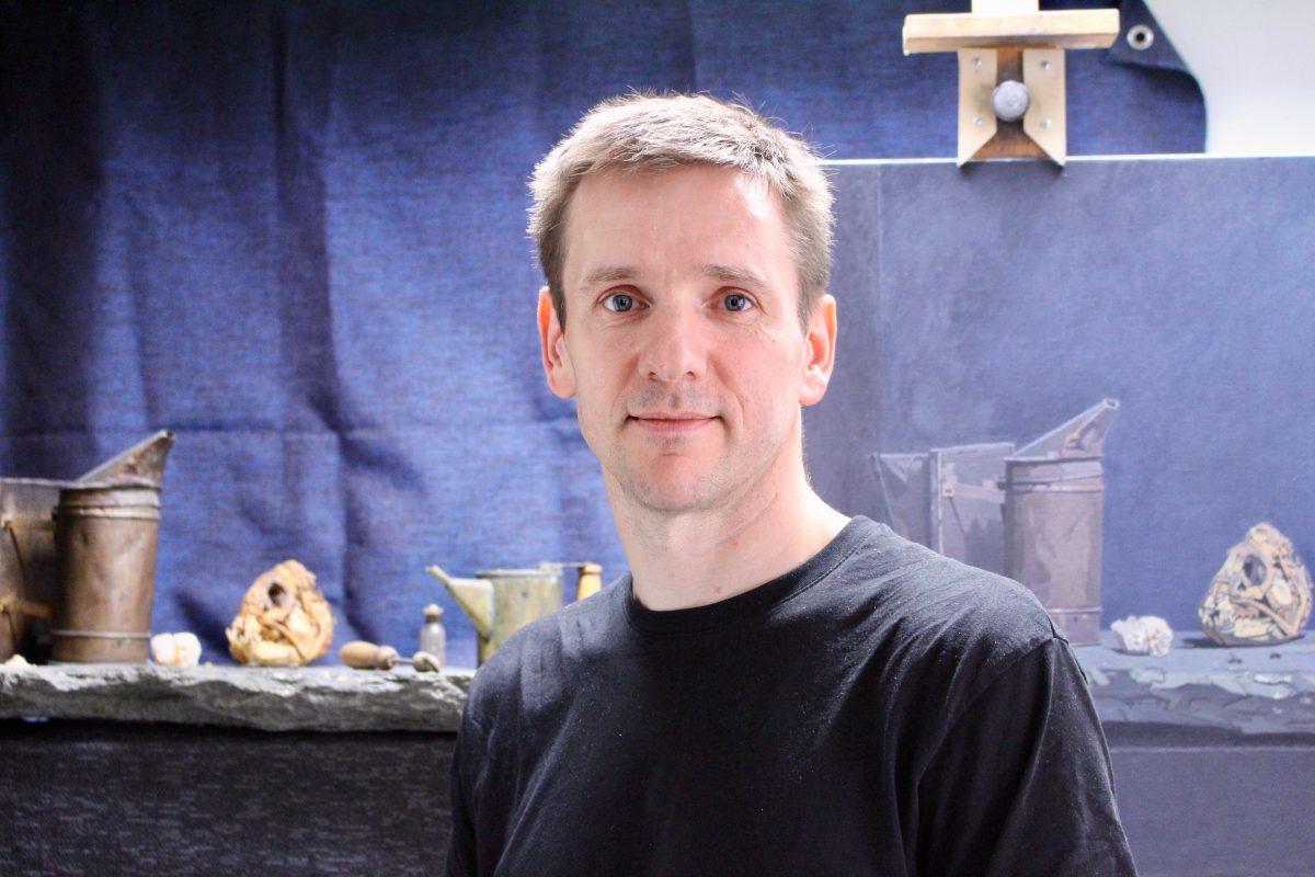 The artist Atle Skudal in his studio in Bergen, Norway, on Aug. 8, 2018. In the background is a work in progress, a bee-themed still life. (Susanne W. Lamm/The Epoch Times)