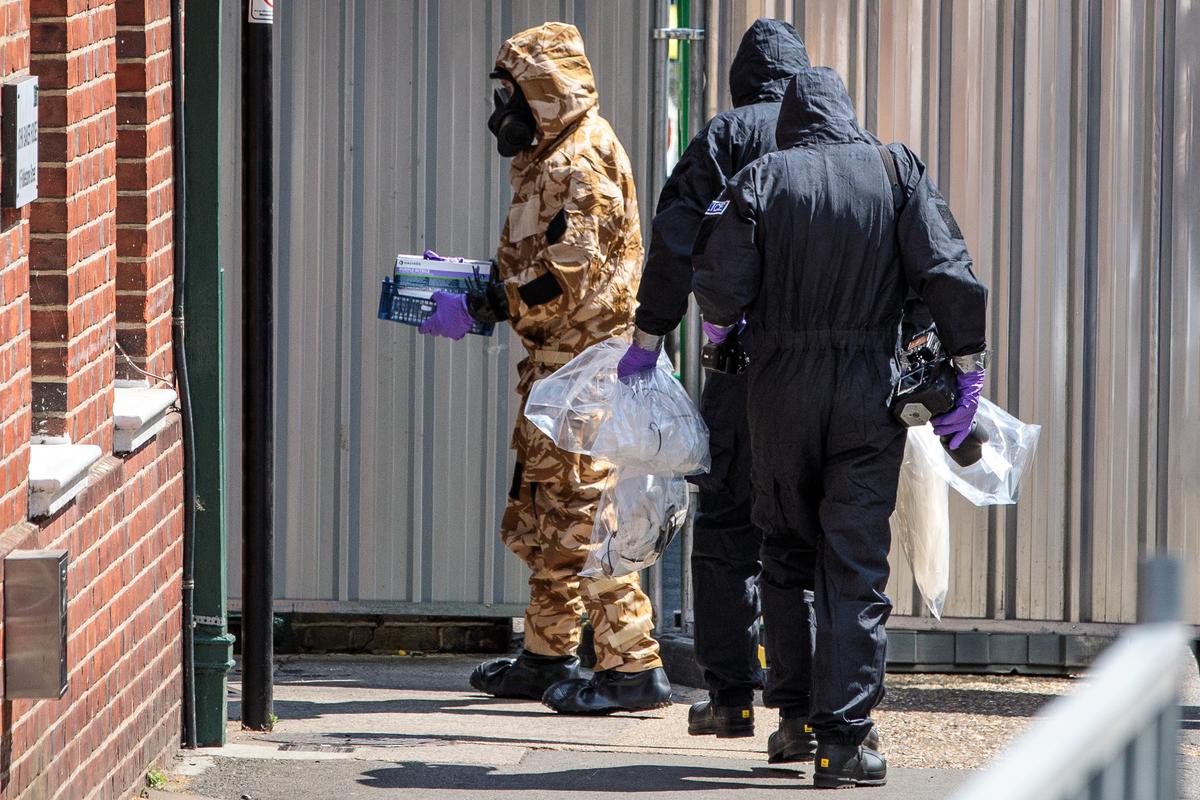 Emergency workers in protective suits search a residence in Salisbury, England, in which a man and woman were exposed to the novichok nerve agent on July 6, 2018. (Jack Taylor/Getty Images)