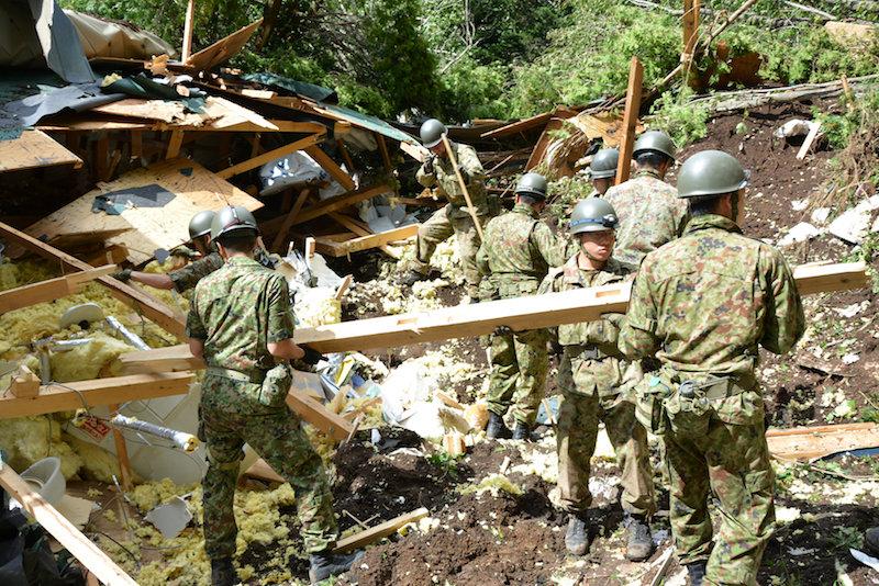 Members of the Japan Self-Defense Forces (JSDF) search for survivors from a house damaged by a landslide caused by an earthquake in Atsuma town, Hokkaido, northern Japan, Sept. 6, 2018. (Japan Self-Defense Forces/Reuters)