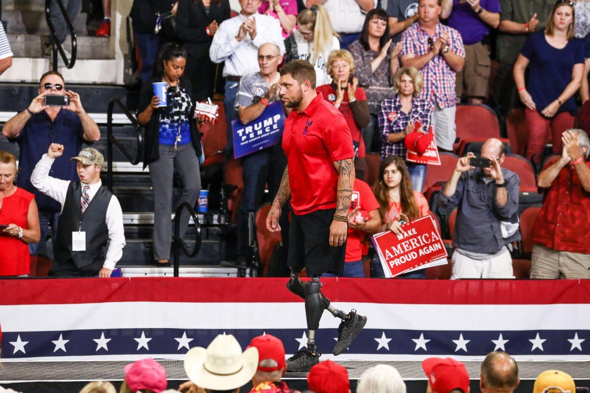 Bo Reichenbach, a double-amputee military veteran, walks onstage to lead the Pledge of Allegiance at President Donald Trump’s Make America Great Again rally in Billings, Mont., Sept. 6, 2018. (Charlotte Cuthbertson/The Epoch Times)