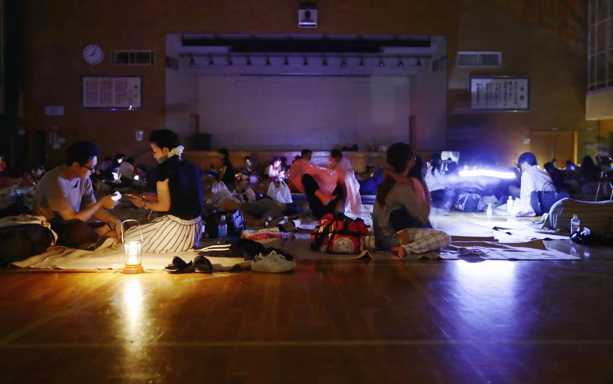 Evacuees are seen at a gymnasium of elementary school, acting as an evacuation shelter, during blackout after an earthquake hit the area in Sapporo, Hokkaido, northern Japan, in this photo taken by Kyodo Sept. 6, 2018. Mandatory credit (Kyodo/via Reuters)