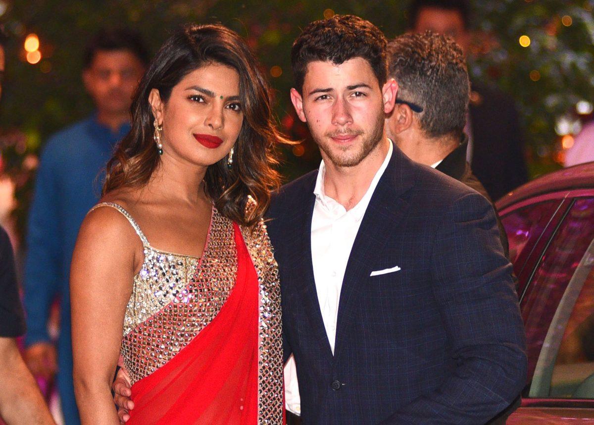 Actress Priyanka Chopra (L) and Nick Jonas (R) arrive for the pre-engagement party of India's richest man in Mumbai on June 28, 2018. (Photo by Sujit Jaiswal / AFP)