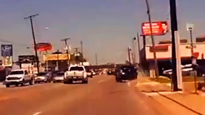 Cody Davis swerves from the far left lane of oncoming traffic to the far right lane and even onto the sidewalk to try to keep ahead of the pursuing police. (Screenshot/NTD)