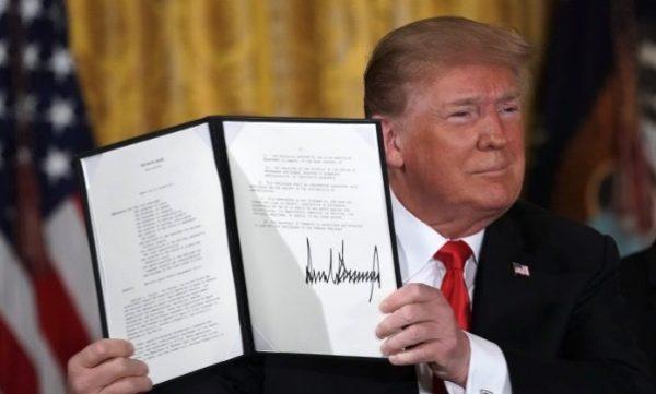 President Donald Trump holds up an executive order for the creation of a Space Force, during a meeting of the National Space Council at the East Room of the White House June 18, 2018, in Washington. (Alex Wong/Getty Images)
