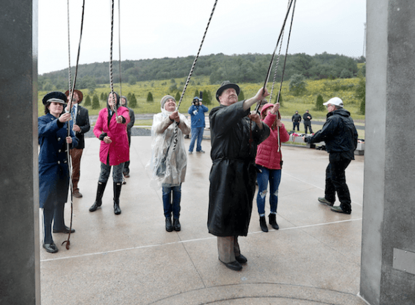 Members of passenger families, friends and volunteer repesentatives pull the ropes to ring the chimes at the dedication of the 93-foot tall Tower of Voices on Sept. 9, 2018 at the Flight 93 National Memorial in Shanksville, Pa.(AP Photo/Keith Srakocic, Pool)
