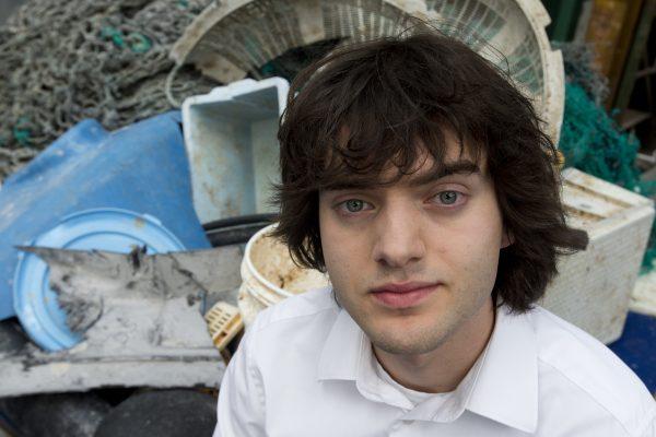 Dutch innovator Boyan Slat poses for a portrait next to a pile of plastic garbage prior to a press conference in Utrecht, Netherlands. (AP Photo/Peter Dejong, File)